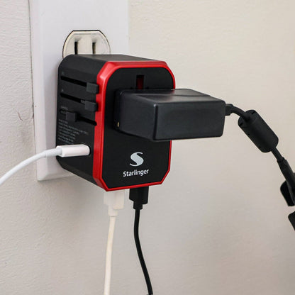 Universal adaptor being used and charging multiple devices.