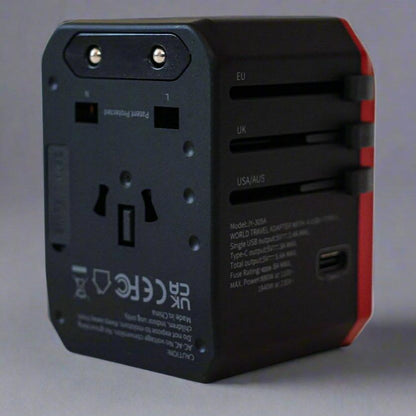 Outlet entry of red and black universal adaptor for travel.